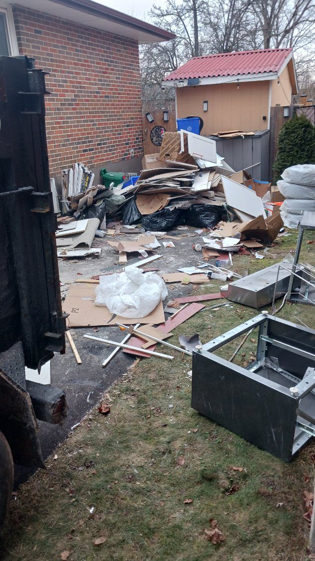 Renovation debris ready for removal beside a home