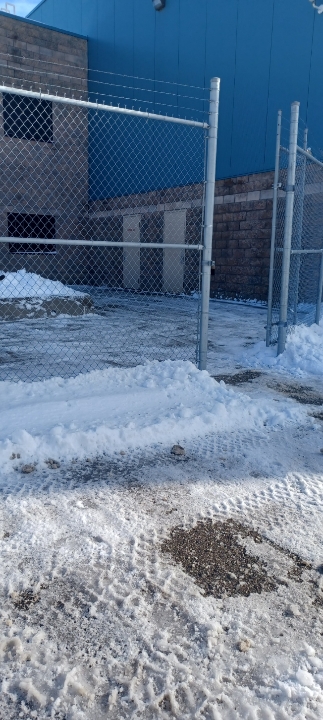 Cleared gated entrance beside a commercial building