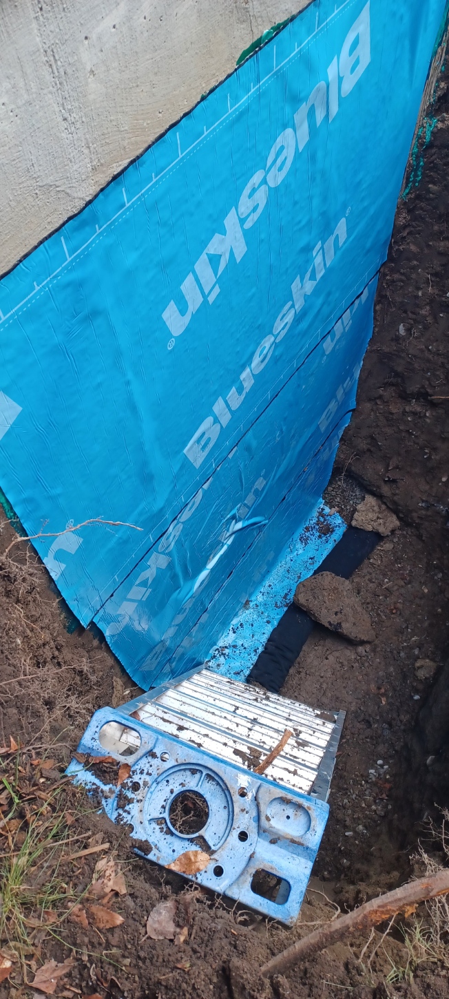 Blue waterproof membrane installed on a foundation wall
