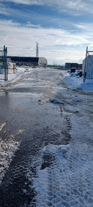 Cleared access road through a commercial property after snowfall